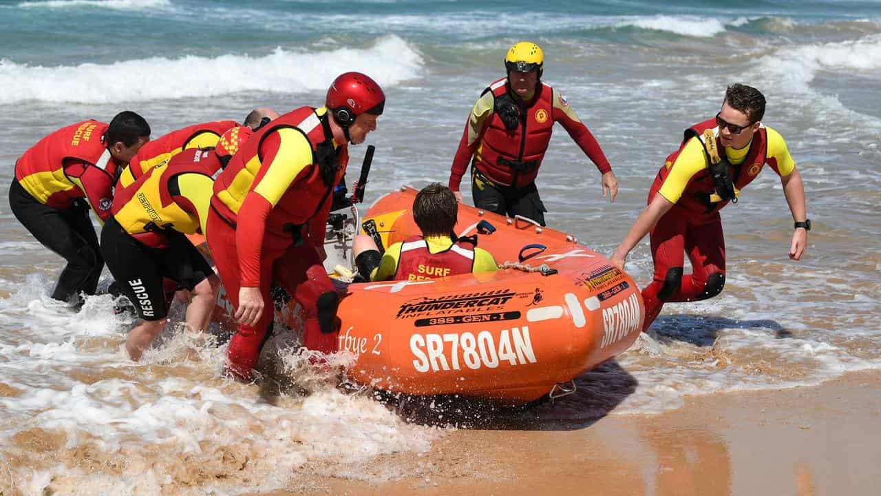 Surf life savers perform a rescue drill.