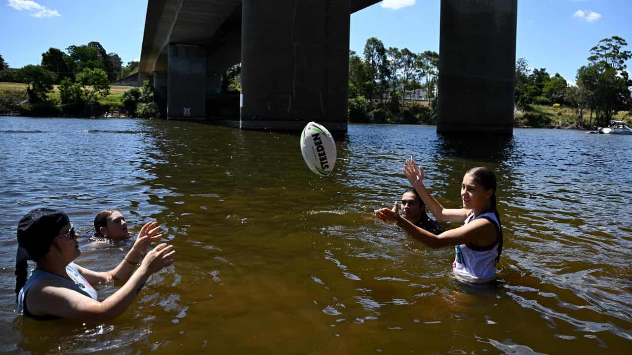 People cool off in the Nepean river at Penrith.