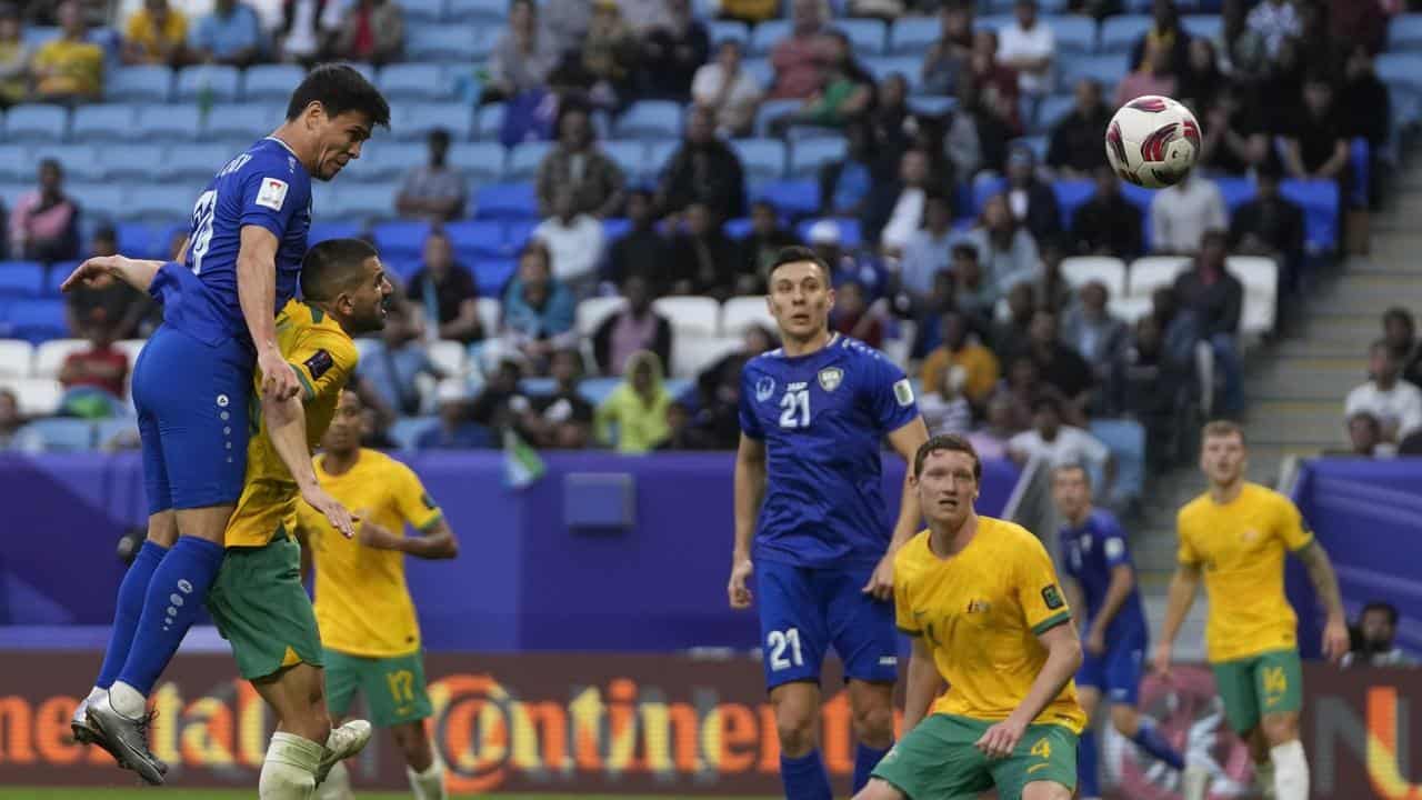 Azizbek Turgunboev climbs above Aziz Behich