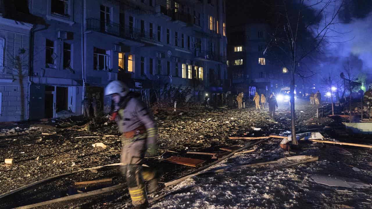 Ukrainian rescuers at the site of a rocket attack in downtown Kharkiv