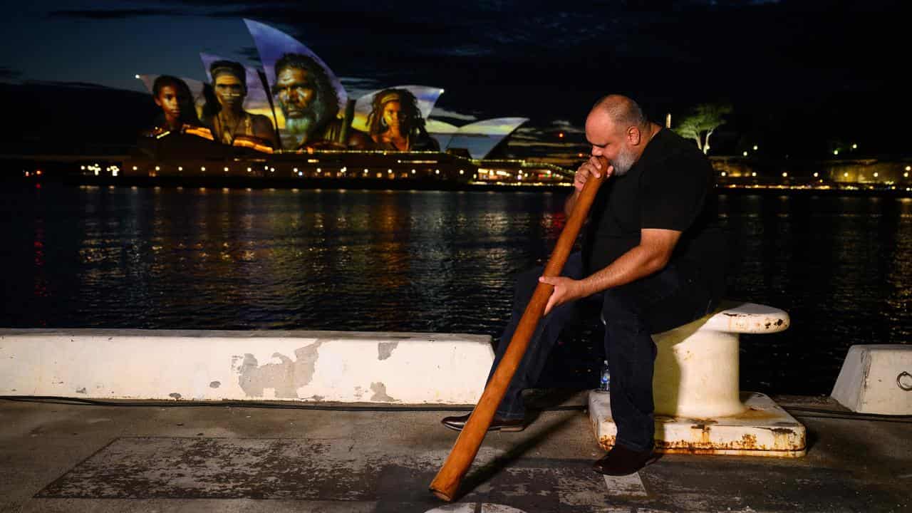 Nathan Scott plays the didgeridoo and illuminated Opera House sails