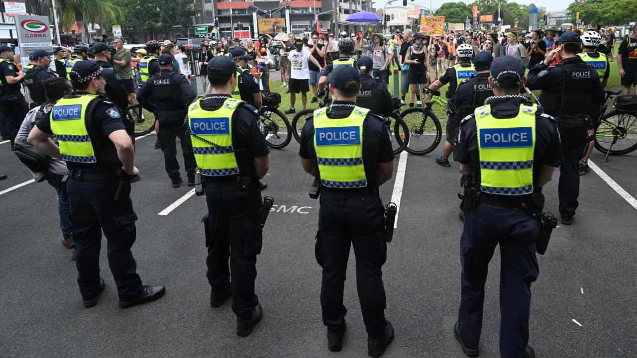 Police and protesters outside the Gabba