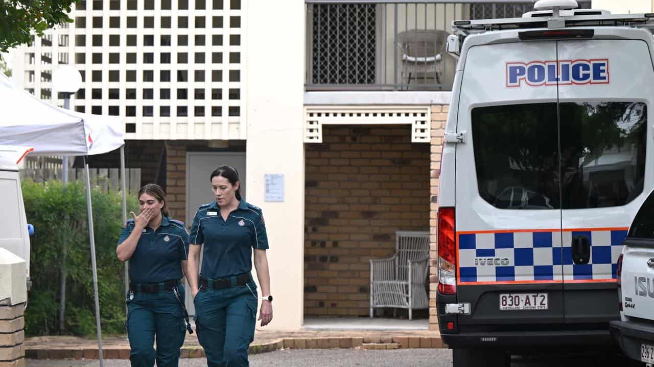 Paramedics and Police are seen at the scene of a fatal stabbing