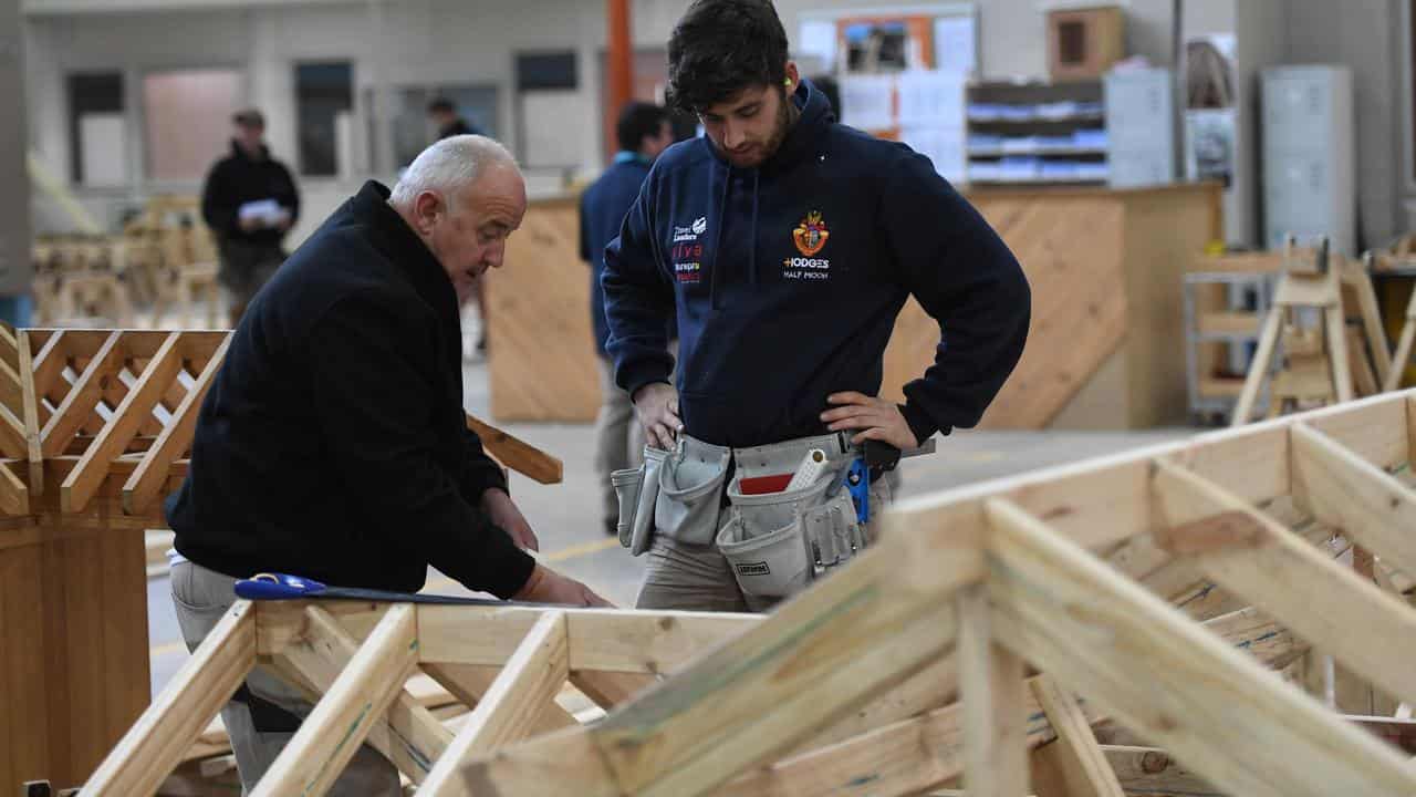 A master and apprentice carpenter