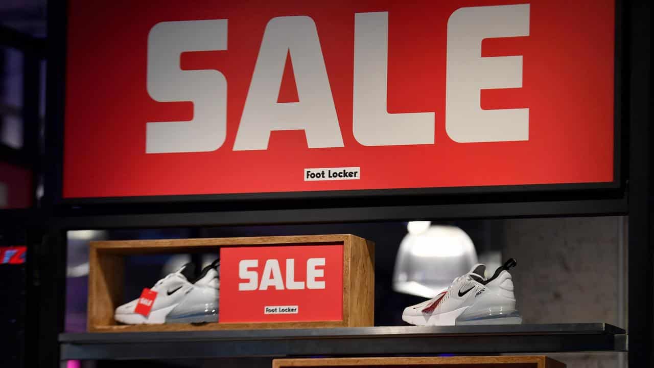 Sale signage is seen in the windows of retail stores in Sydney,