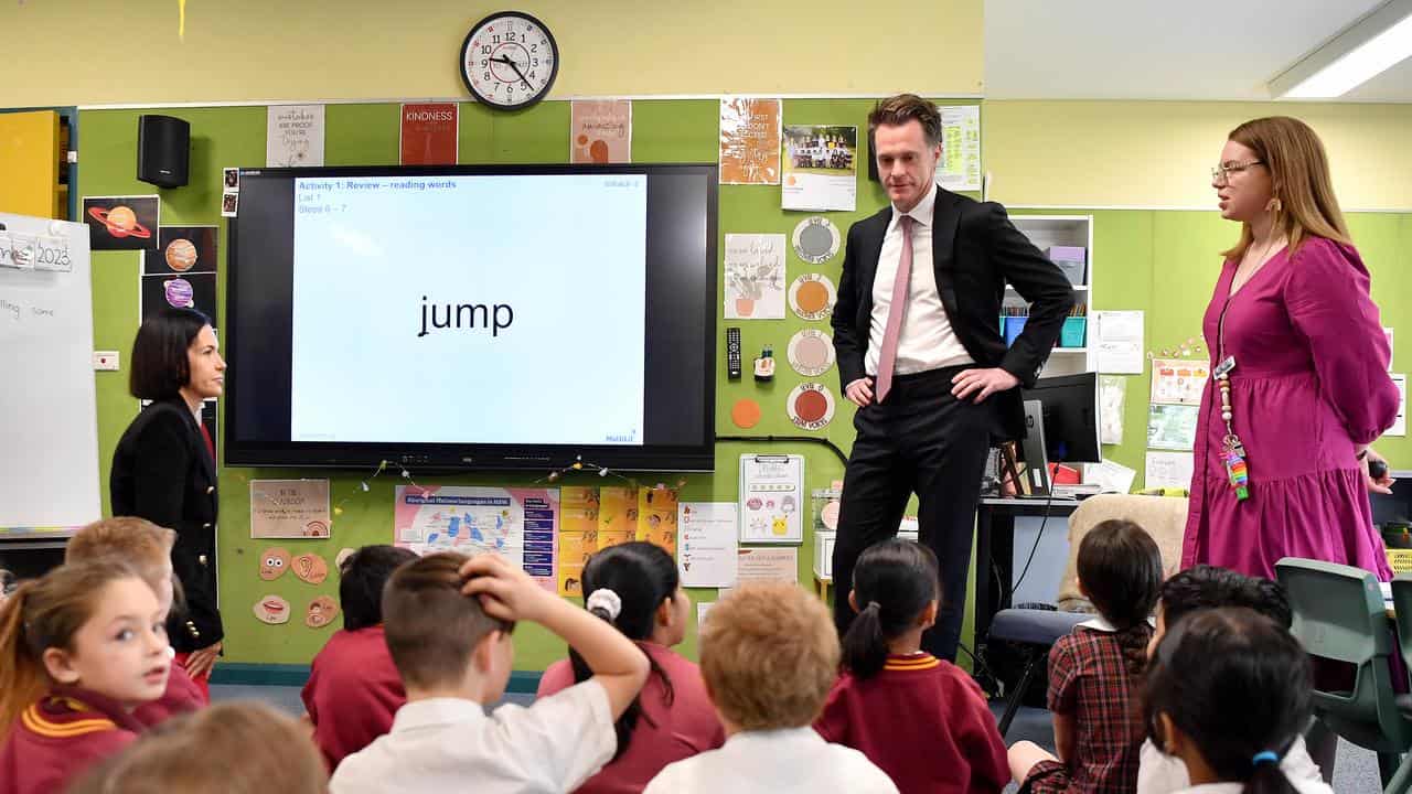 Chris Minns at front of classroom with 'jump' written on the board