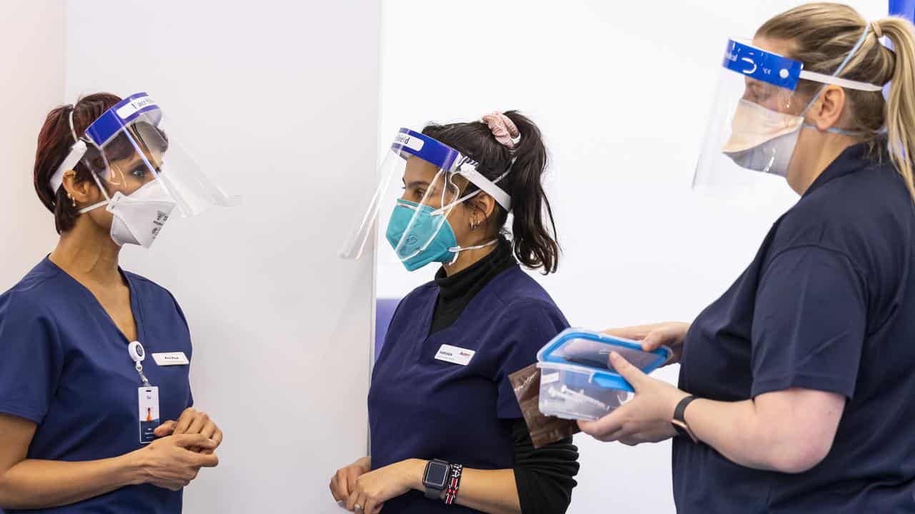 Health care workers are seen in the COVID vaccination hub