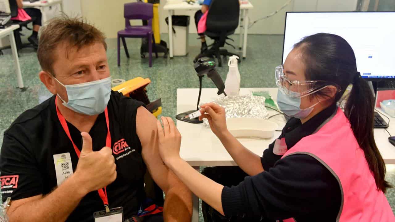 A man receives his booster Pfizer vaccine