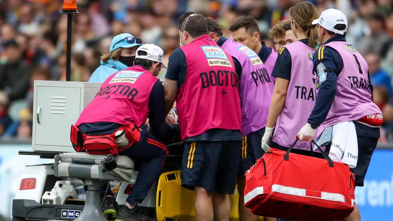 Medics deal with an on-field concussion at the AFL. 