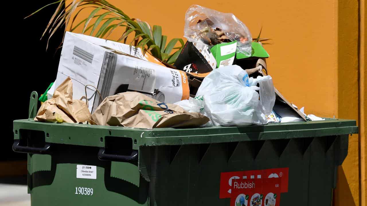 Overflowing household rubbish bins