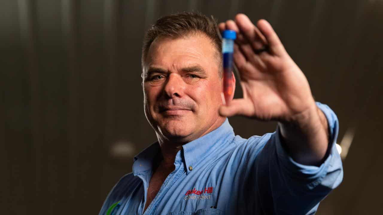 Adam Randall of Cobalt Blue holds a vial of cobalt sulphate.