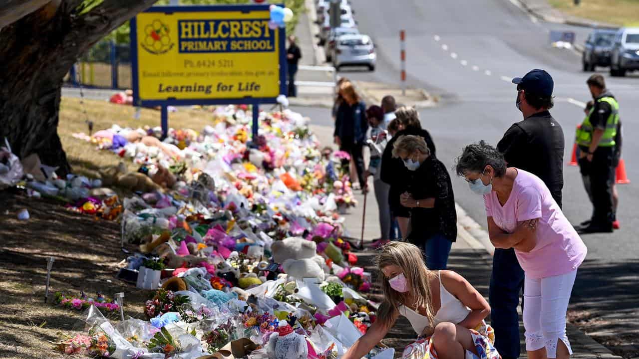 People pay their respects outside the school (file image)