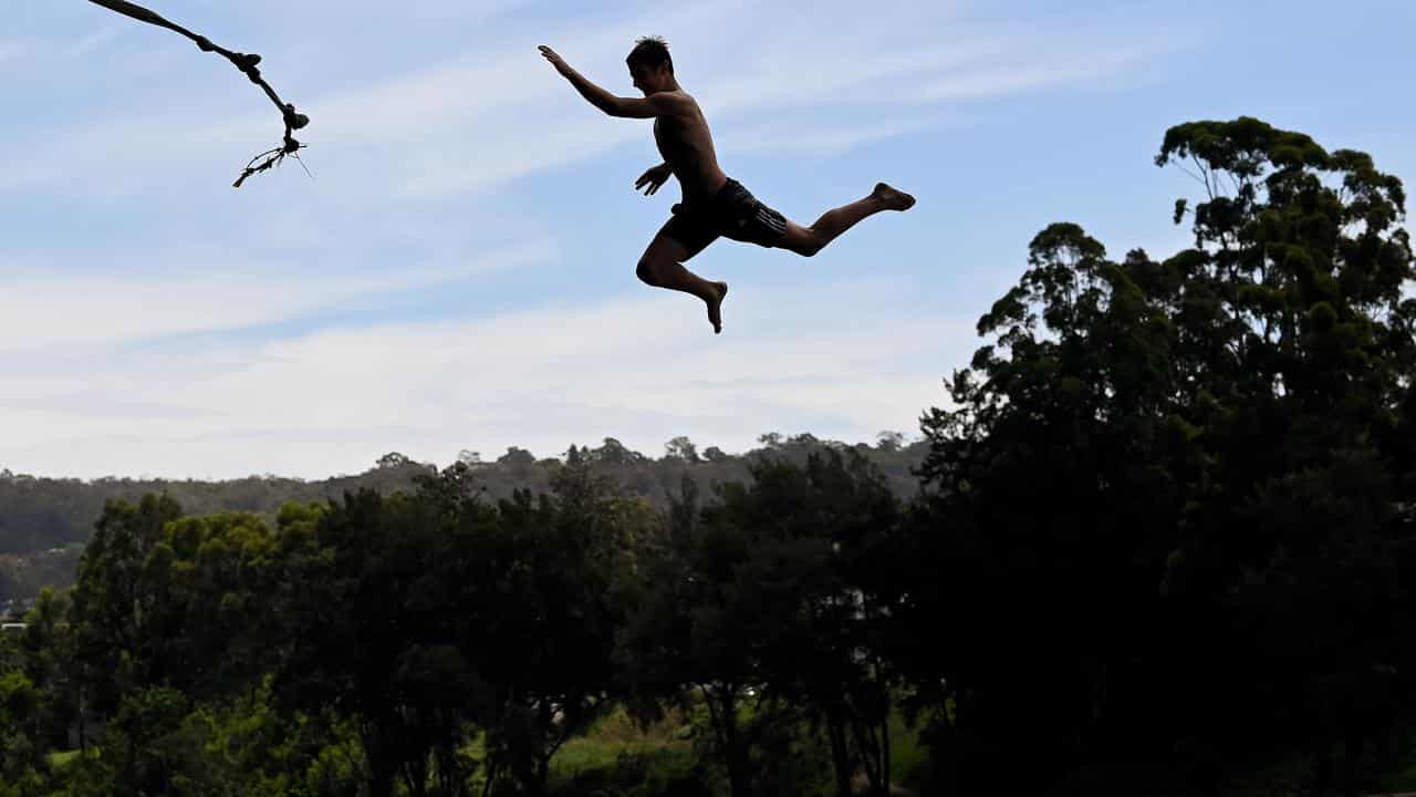 Locals cool off with a rope swing into the Nepean River near Penrith