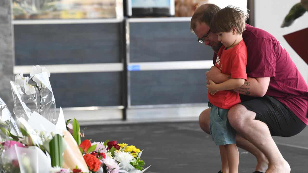 Residents lay flowers