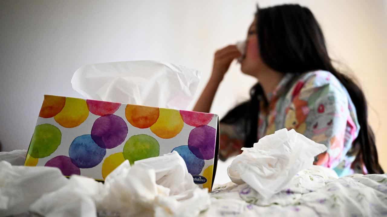 A young woman uses tissues (file image)