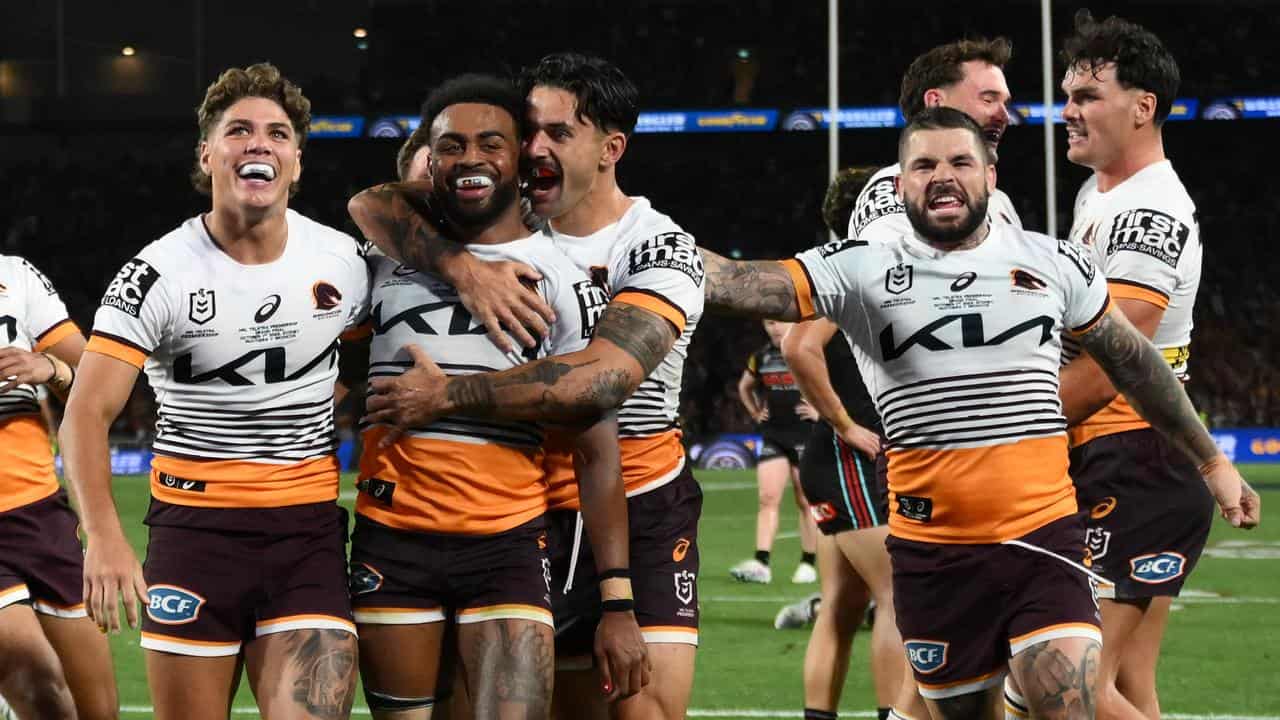 Ezra Mam (second left) celebrates one of his grand final tries.