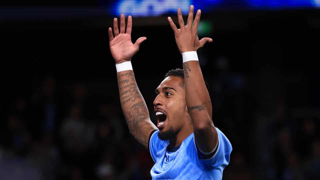 Sydney FC's Fabio Gomes throws his hands up. 