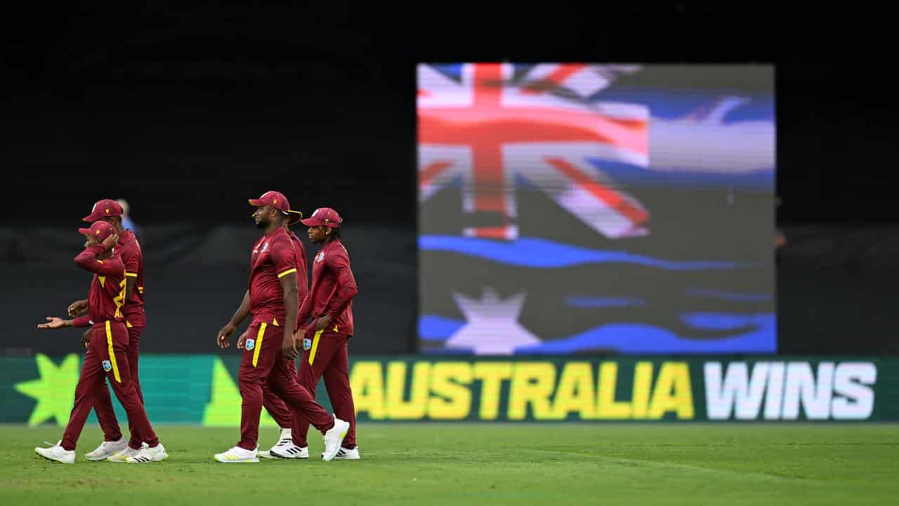 West Indies players leave the field.