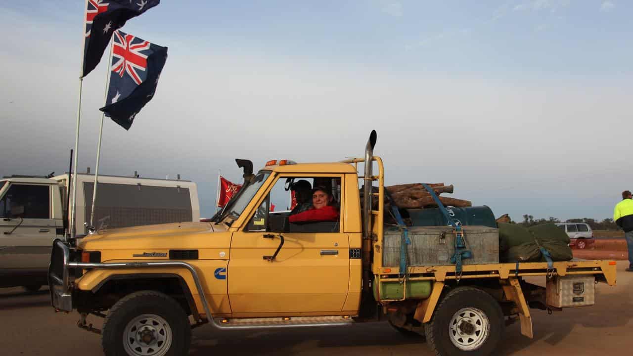 Ute bearing Australian flags.