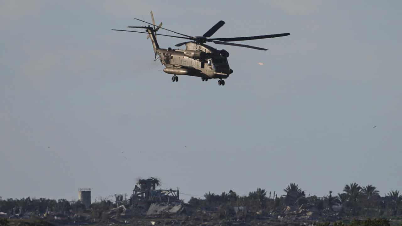 An Israeli military helicopter operates on the edge of the Gaza Strip