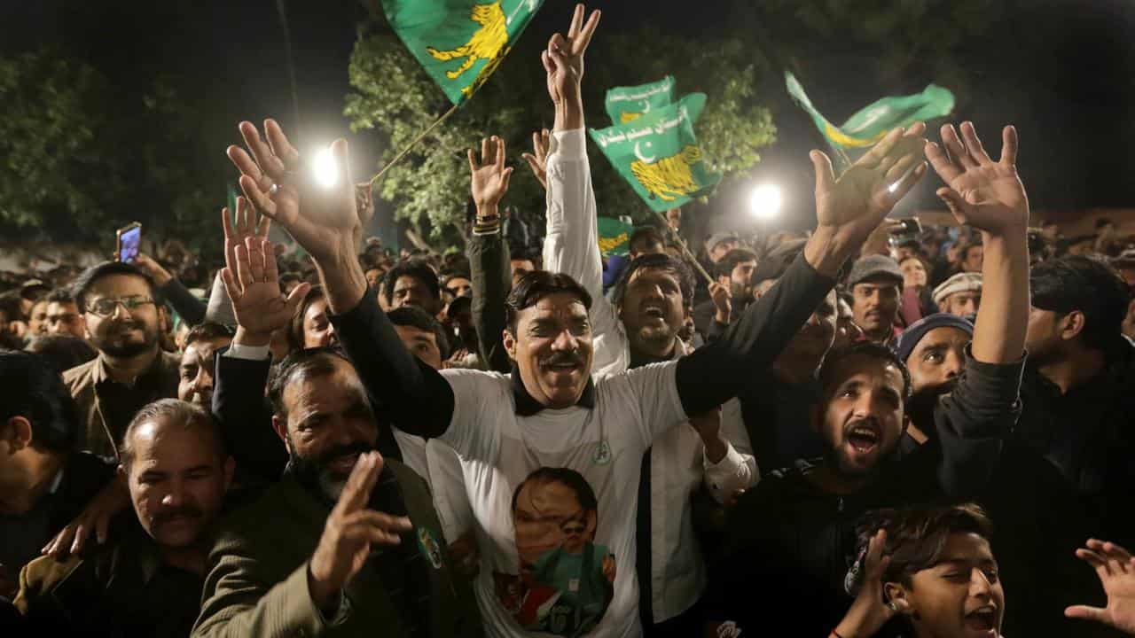 Supporters of Nawaz Sharif react as he speaks in Lahore, Pakistan