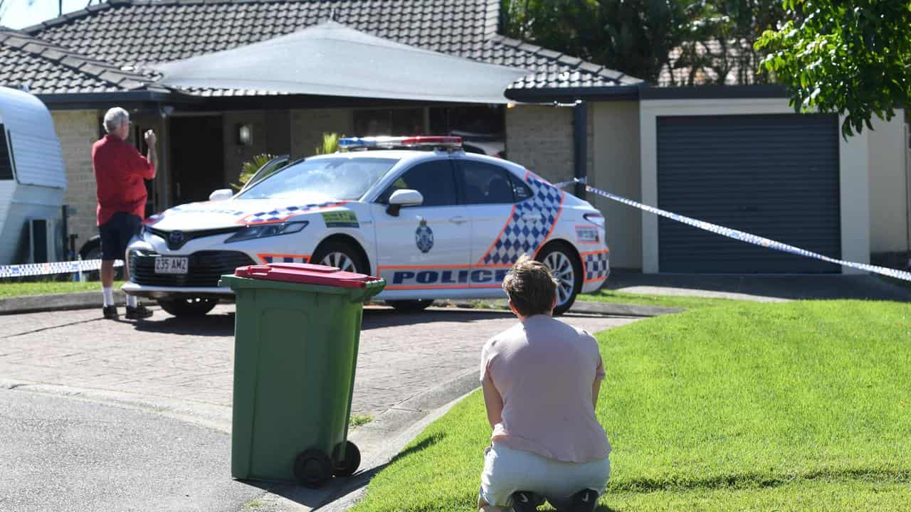 A local resident kneeling outside Kelly Wilkinson's home (file image)