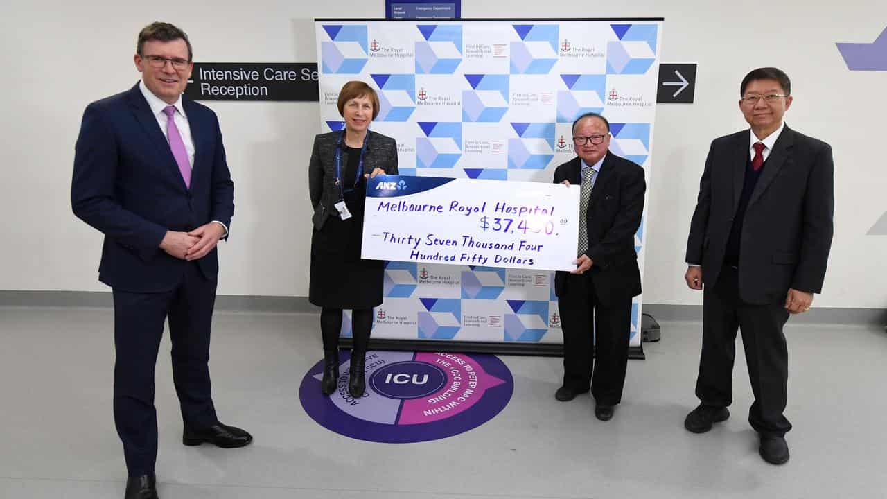 Dong presenting a novelty cheque at the hospital (file image)