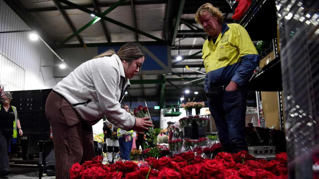 Woman looks at bunch of roses