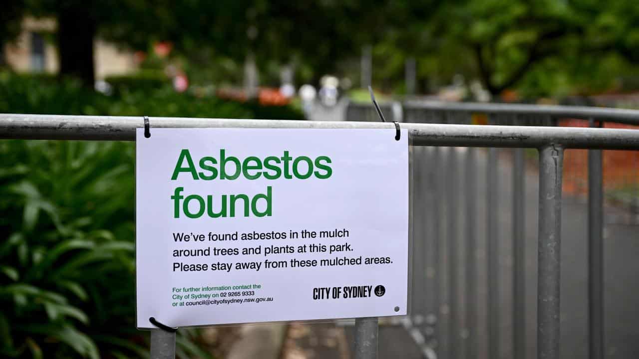 A sign in a Sydney park saying asbestos has been found in mulch. 