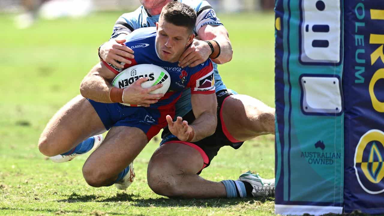 Jack Cogger scores a try for Newcastle against Cronulla.