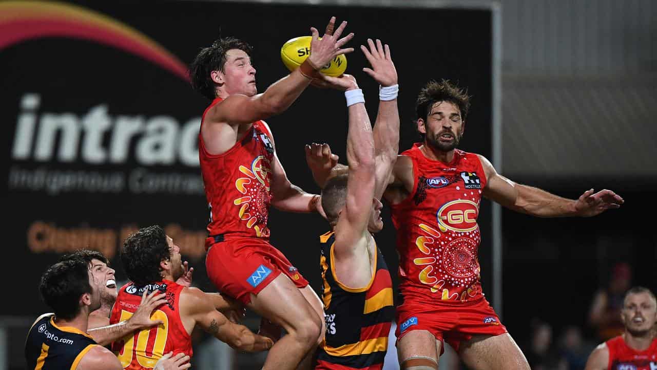 Bailey Humphrey (centre) wins the ball for Gold Coast.