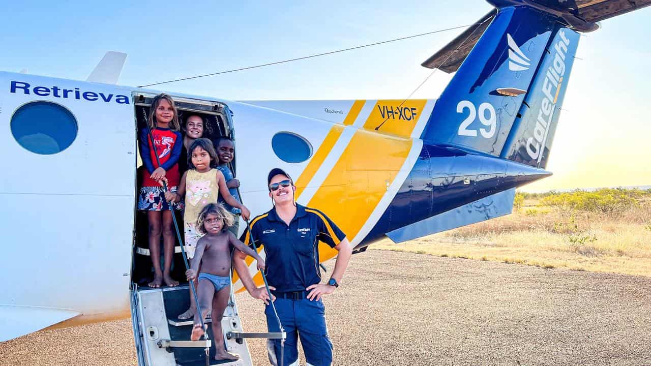 A CareFlight pilot poses with some of the locals during the mission.