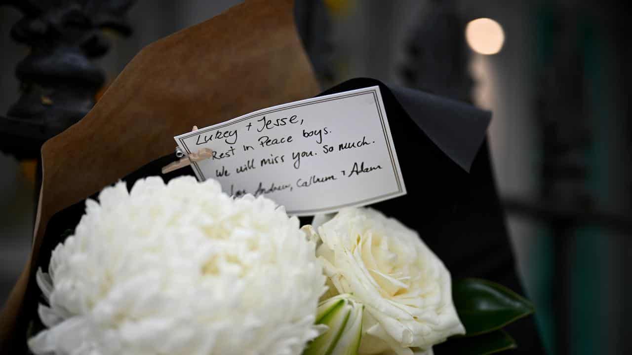 A closue up of a condolence message on flowers