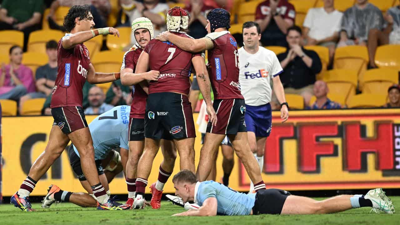 Queensland Reds players celebrating a try.