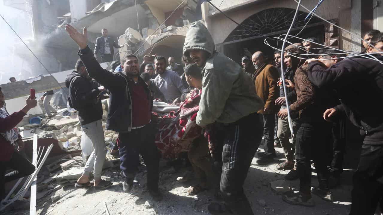 Palestinians after an airstrike in Rafah 