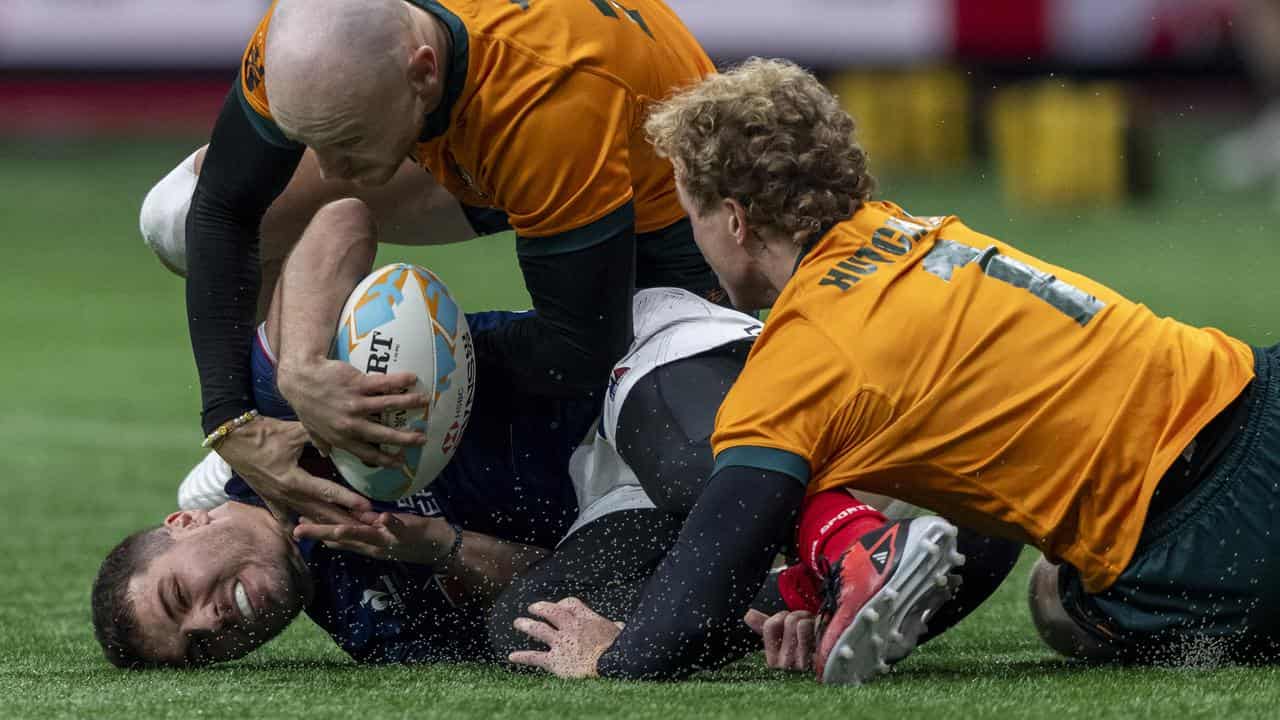 France's Antoine Dupont is tackled by Australia at the Vancouver 7s.