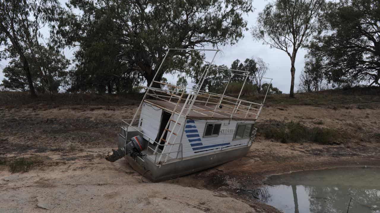 A house boat stuck on the banks of the Darling River.