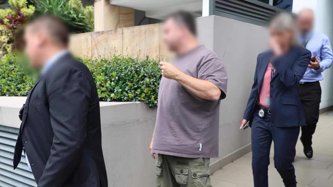 Eddie Hayson (centre) being arrest in Burleigh Heads in Queensland