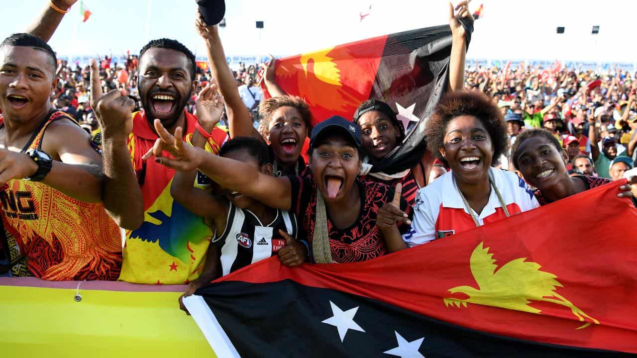 Local PNG fans celebrate a try.