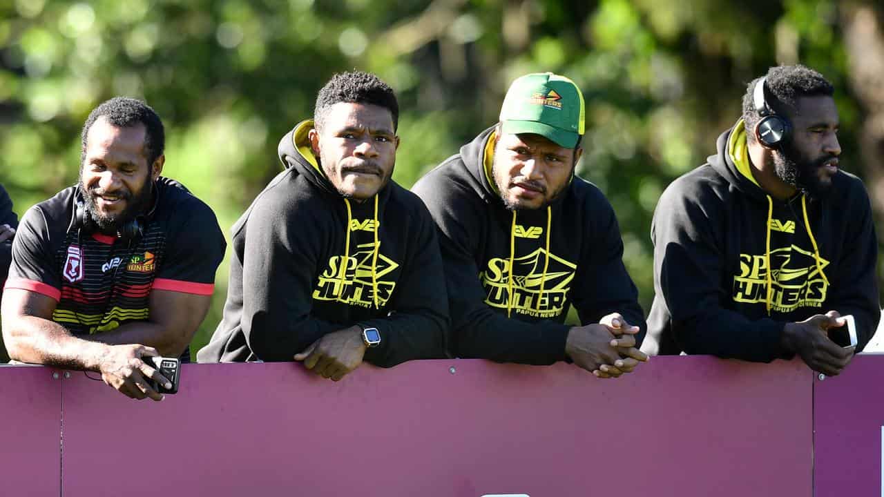 PNG Hunters players watching a Brisbane Broncos training session.