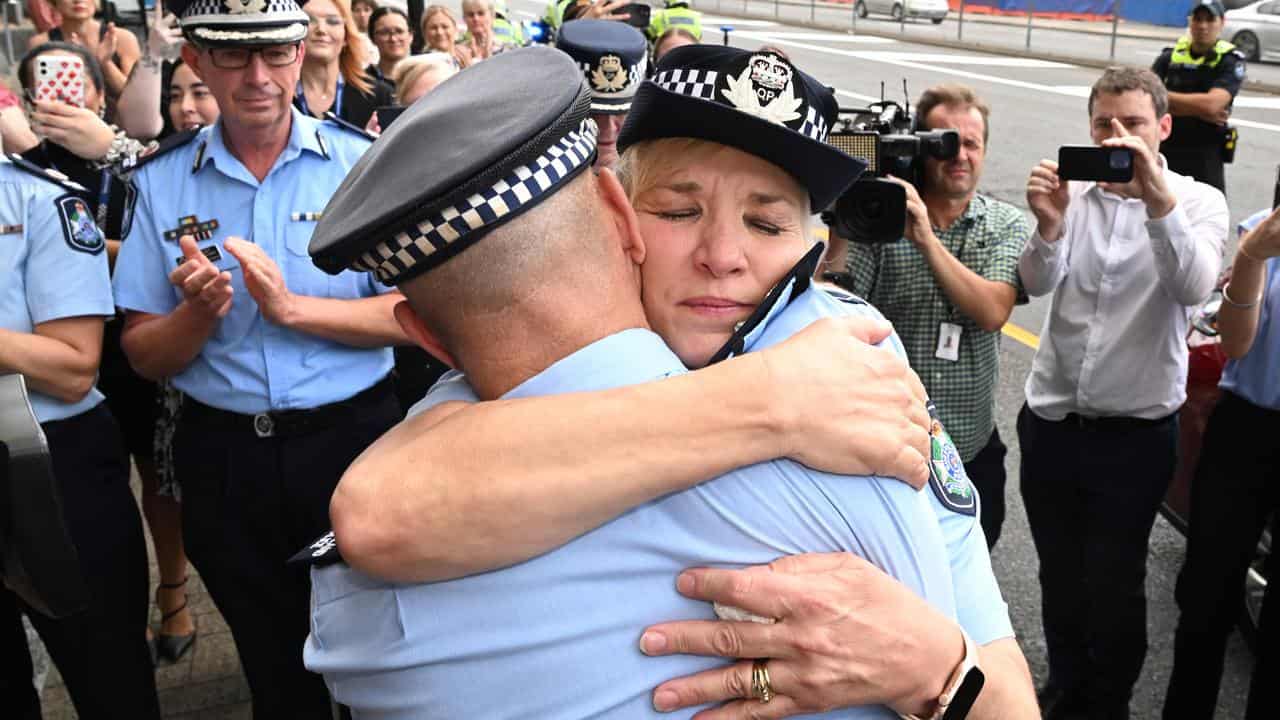 Katarina Carroll hugs deputy police commissioner Steve Gollschewski