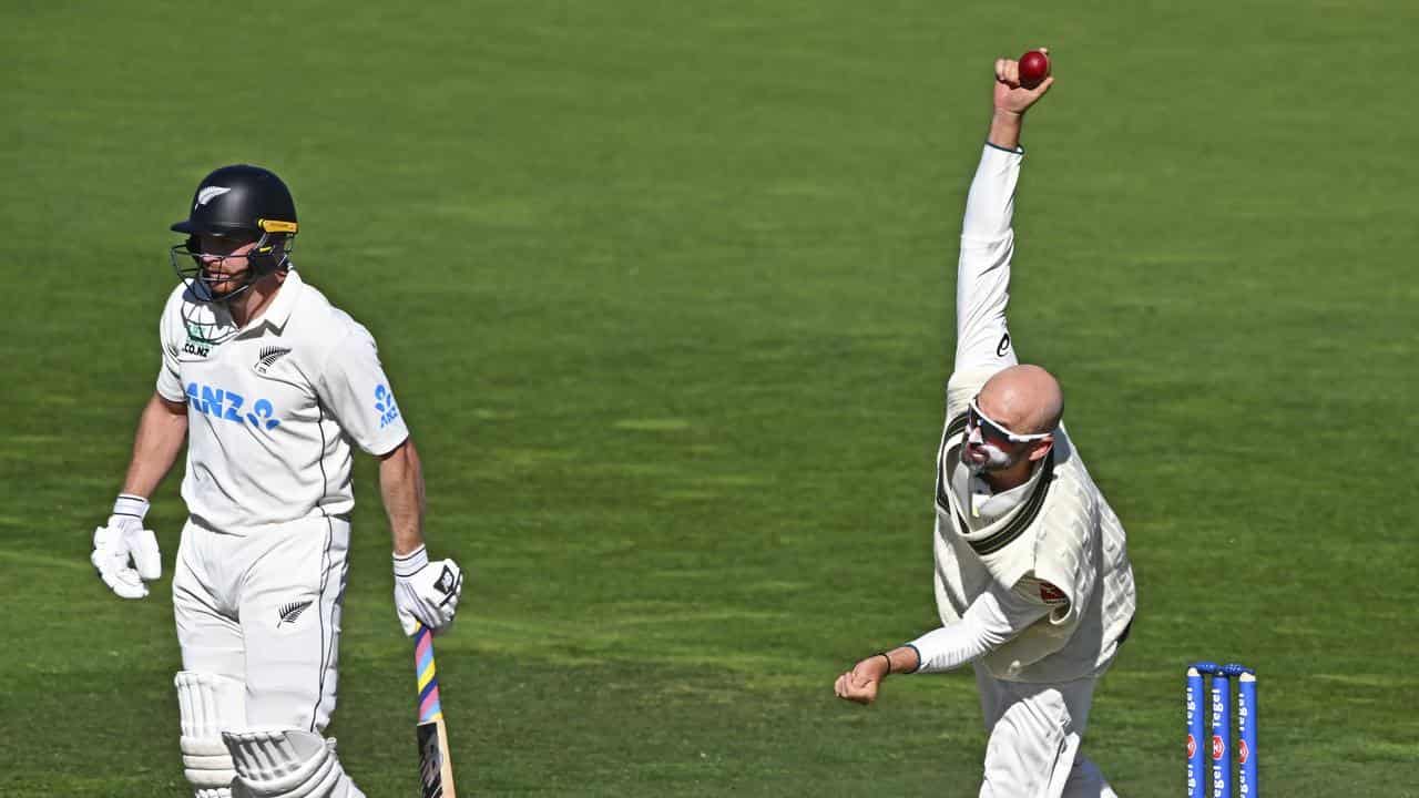 Nathan Lyon bowls against New Zealand. 