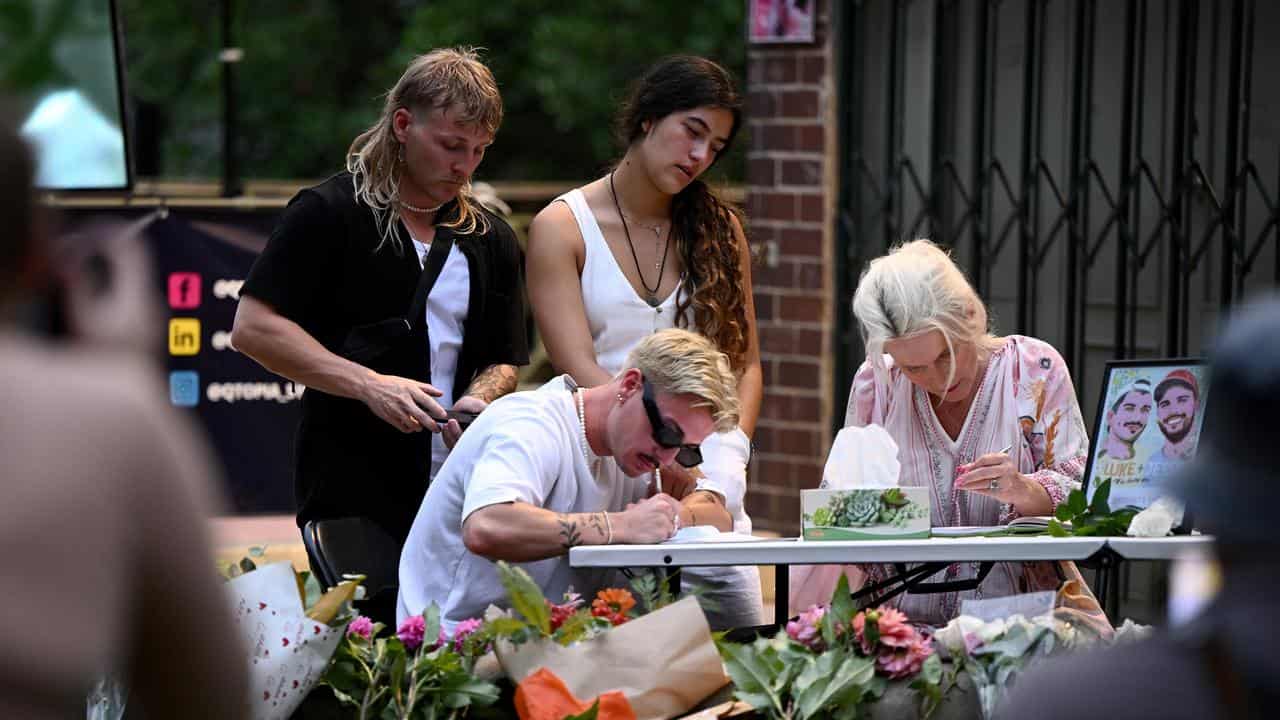 Mourners leave messages during a vigil.