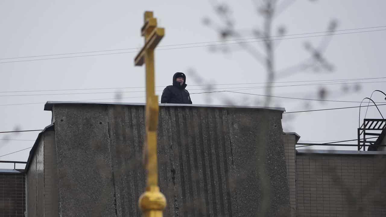 Police on a roof near the Church of the Icon of the Mother of God