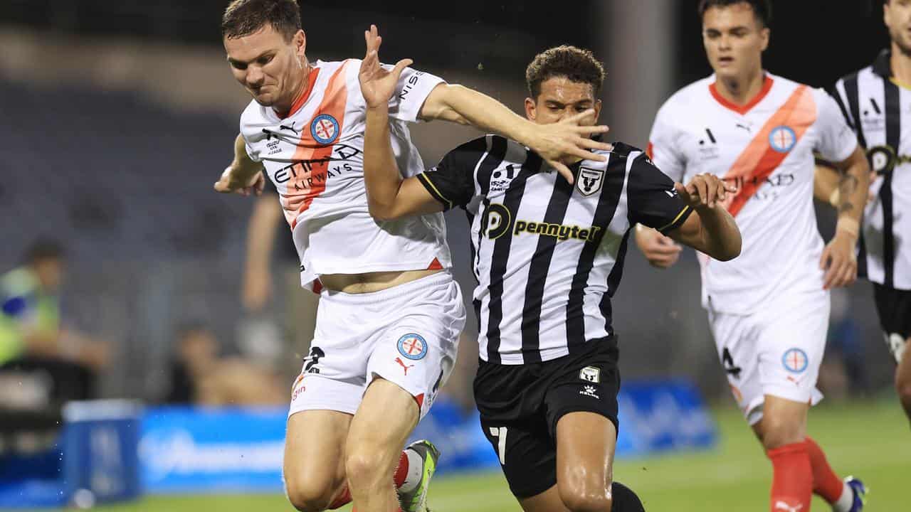 Curtis Good and Raphael Borges Rodrigues compete for the ball.