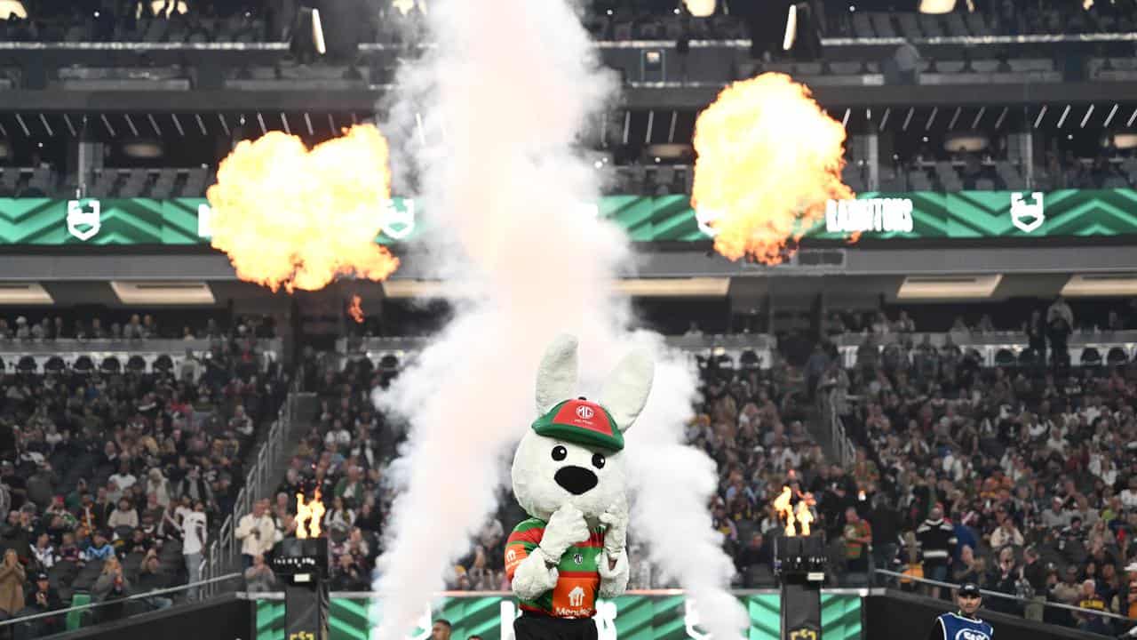 Souths' players and mascot take to the field.