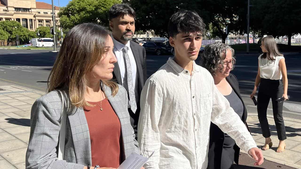 Dhirren Randhawa (centre) exits Adelaide Magistrates Court