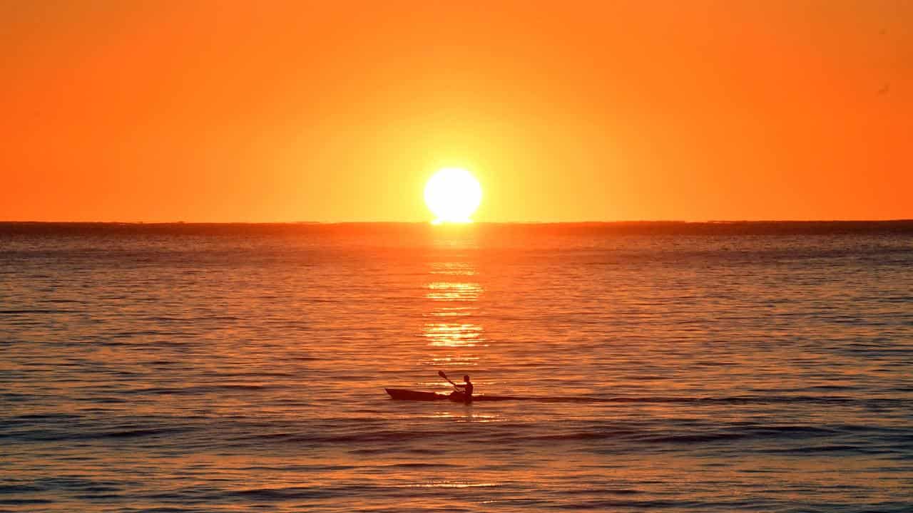 A kayaker paddles at sunrise (file image)