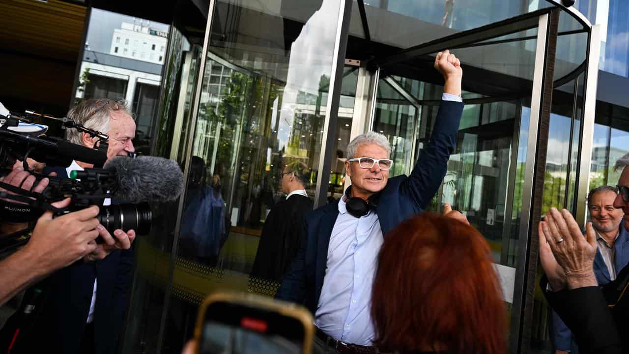 David McBride raises his fist outside the ACT Supreme Court