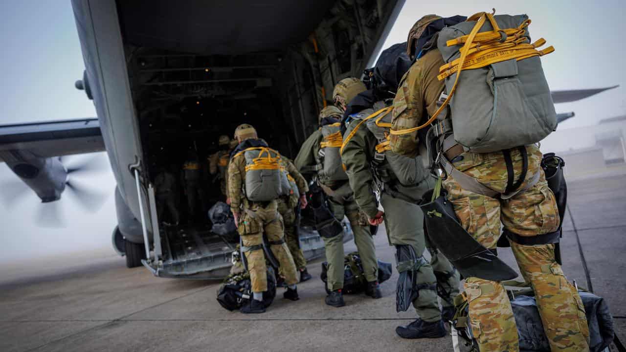 Australian Army special forces soldiers boarding a plane